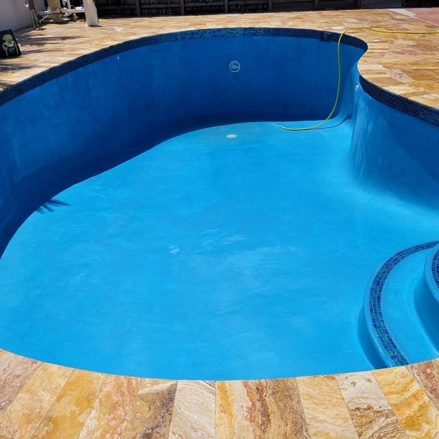 A large swimming pool with blue water and steps