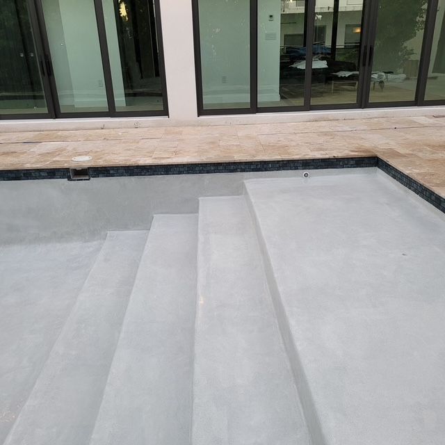 A swimming pool with stairs leading up to it