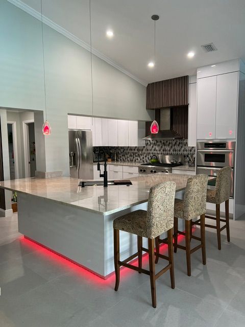 A kitchen with a large island and stools