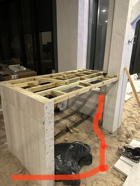 A wooden table is being built in a room.