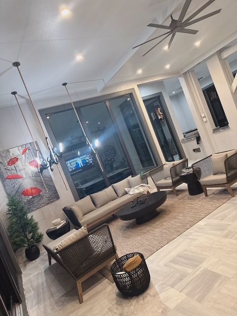 A living room filled with furniture and a ceiling fan.