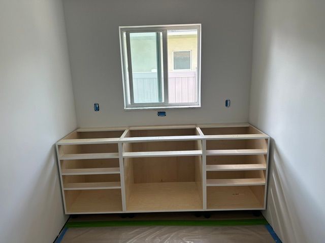 A room with cabinets and a window in it