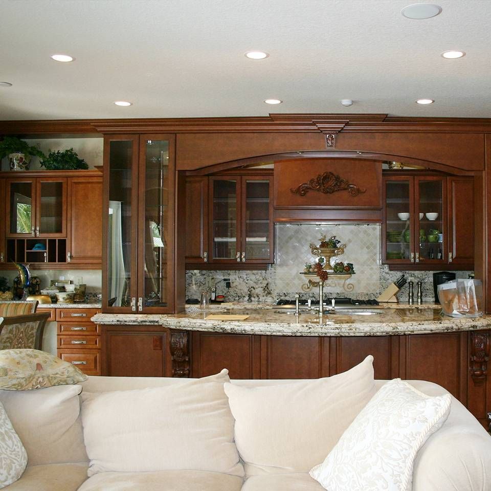 A living room with a couch and a kitchen in the background