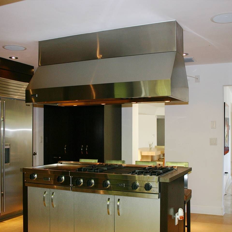 A kitchen with stainless steel cabinets and a stove top oven