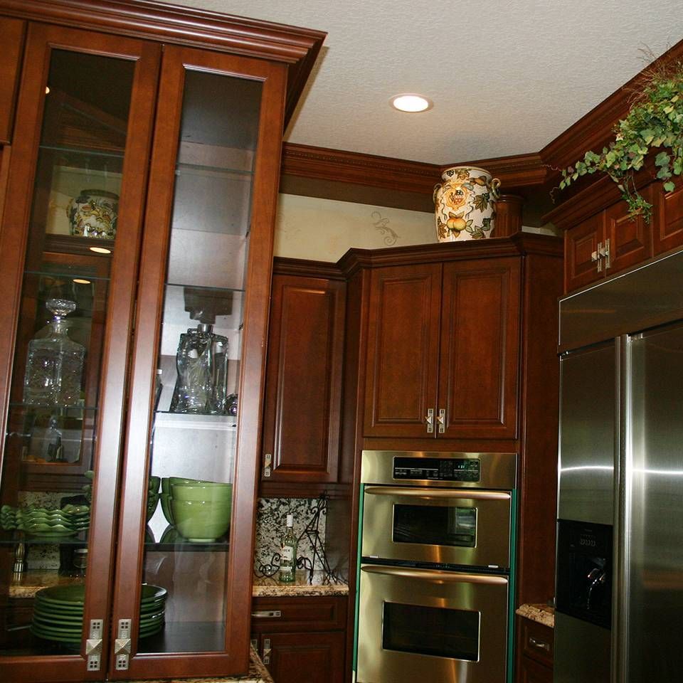 A kitchen with stainless steel appliances and wooden cabinets