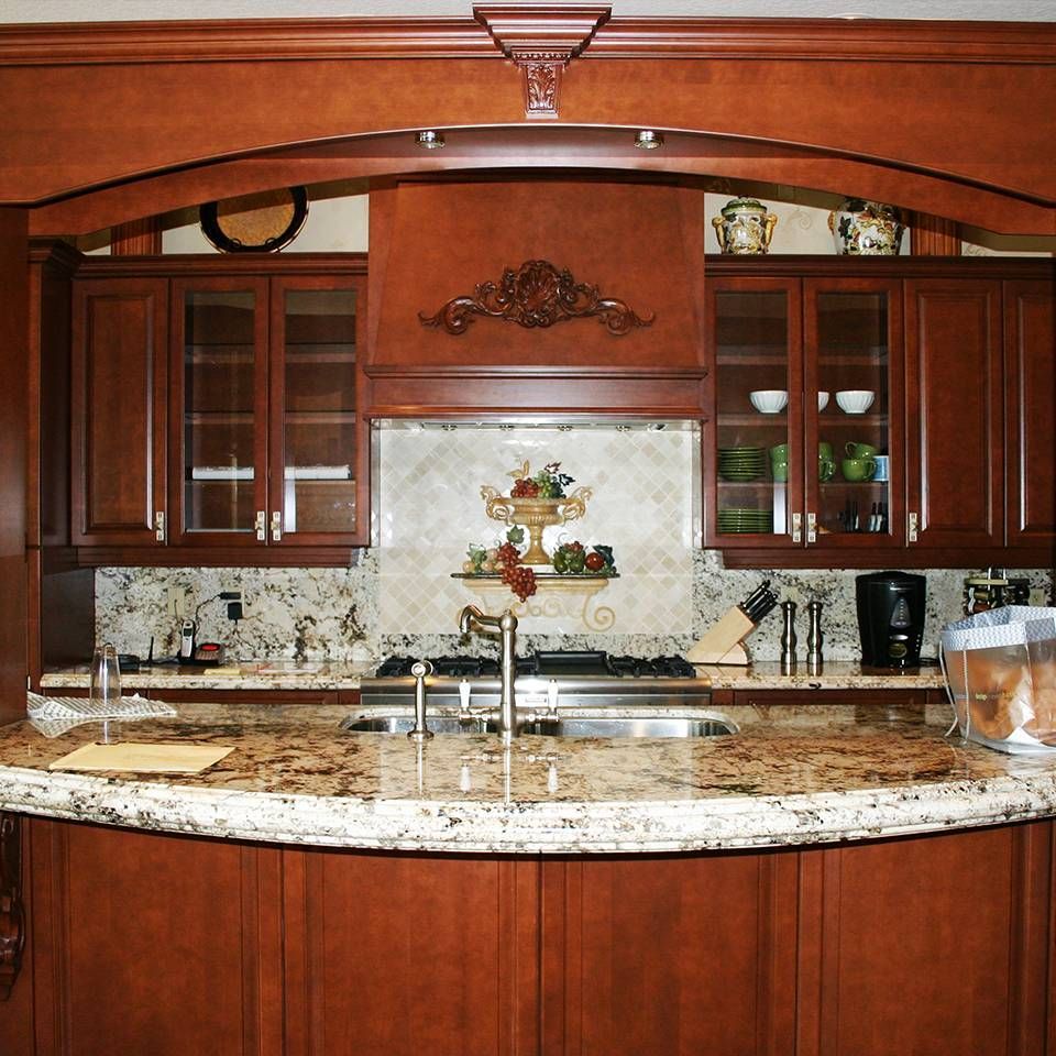 A kitchen with wooden cabinets and granite counter tops