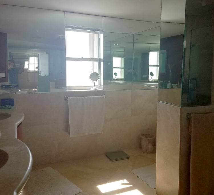 A bathroom with a lot of mirrors and a window