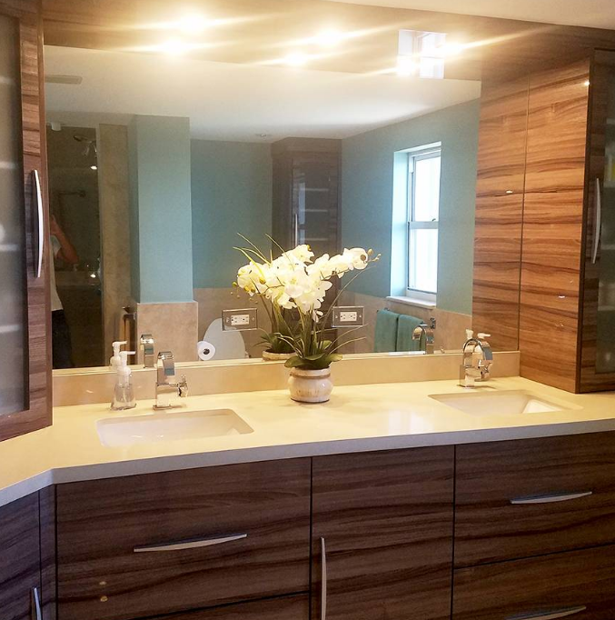 A bathroom with two sinks and a large mirror