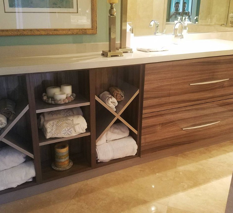 A bathroom with a sink and a picture on the wall