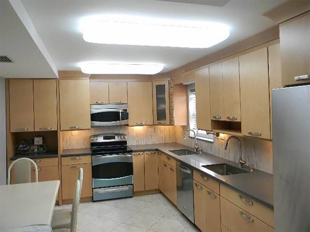 A kitchen with stainless steel appliances and wooden cabinets