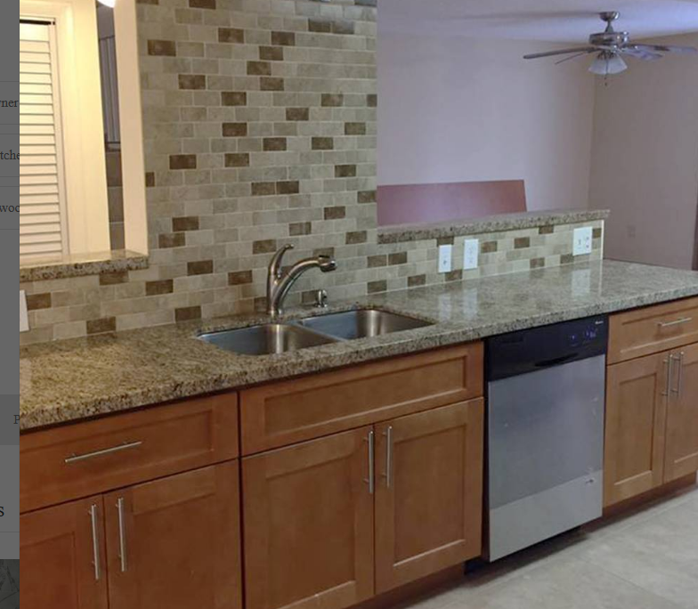 A kitchen with two sinks and a ceiling fan