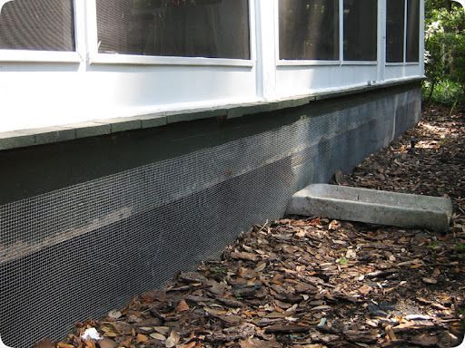 A screened in porch with a concrete foundation