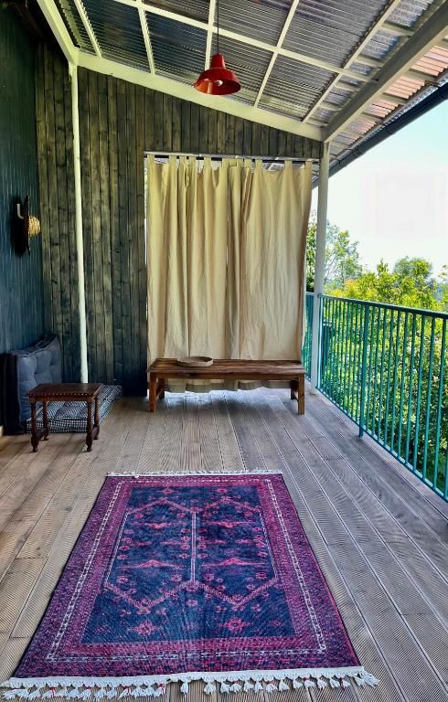 There is a rug on the floor on the balcony.