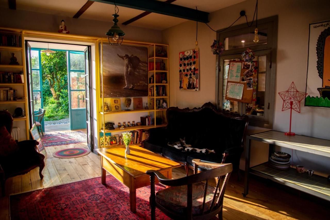 A living room with a couch , chair , table and bookshelf.