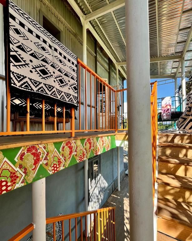 Stairs leading up to a balcony with a blanket on it