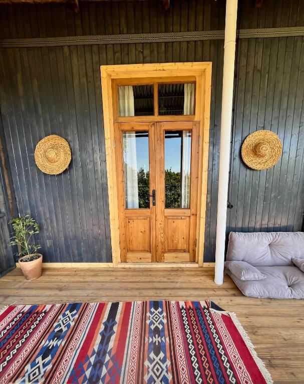 There is a rug on the floor in front of the door.