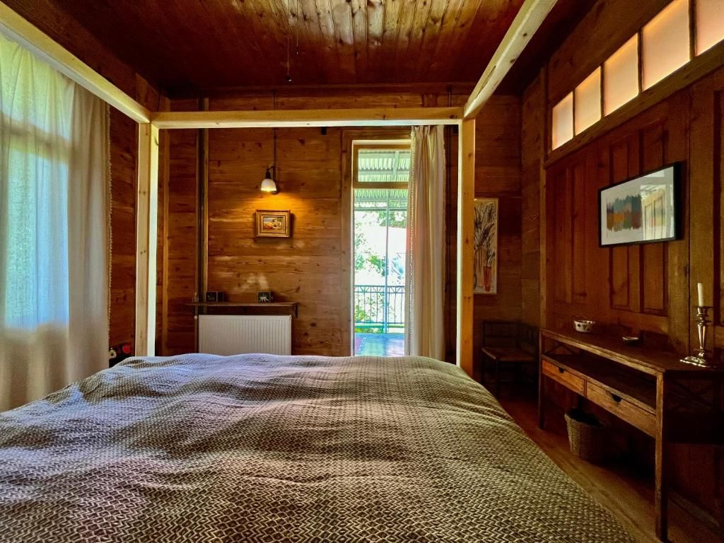 A bedroom with two beds , a desk , and a window.