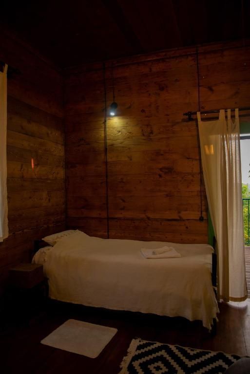 There is a single bed in the middle of the room.