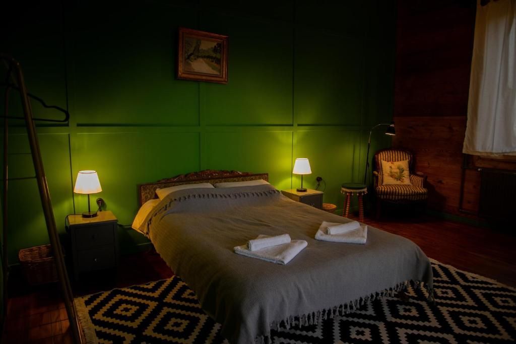 A bedroom with a bed , two lamps , a chair and a rug.