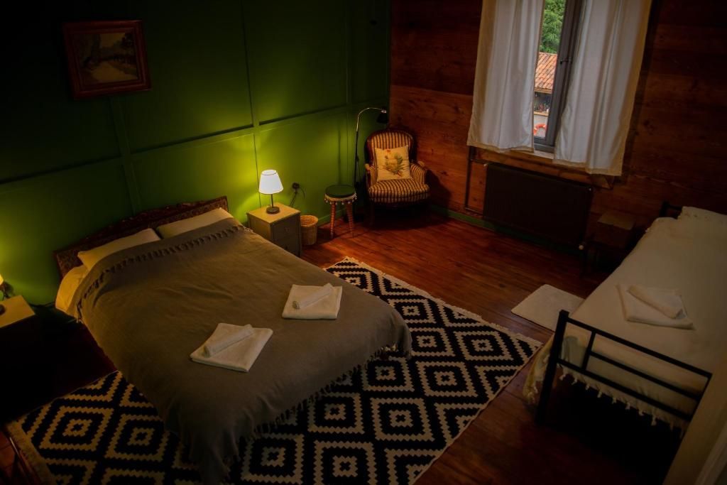 A bedroom with a bed , nightstand , chair and rug.