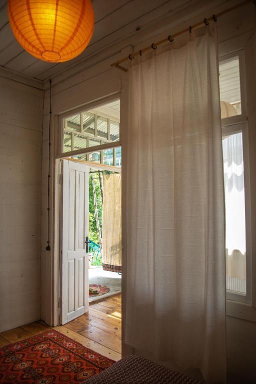 A room with a lantern hanging from the ceiling and a rug on the floor.