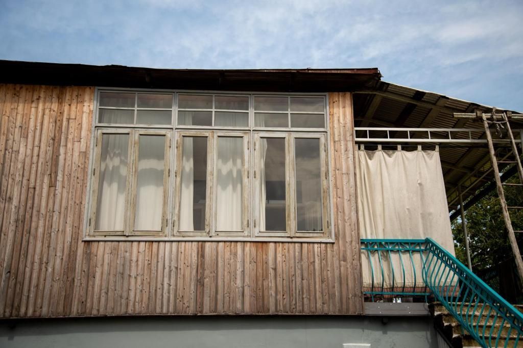 A wooden house with a balcony and stairs