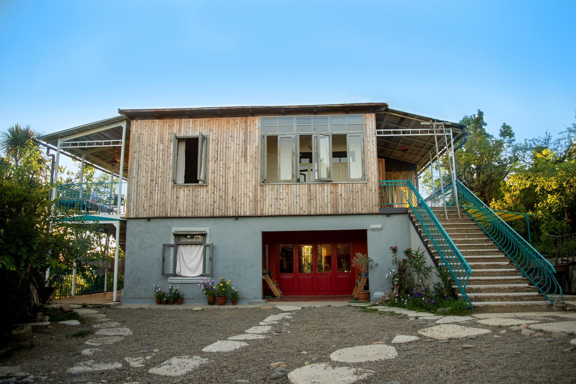 A large wooden house with stairs leading up to it.