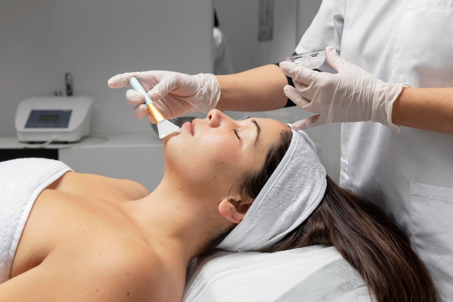 A woman is getting a facial treatment at a spa.