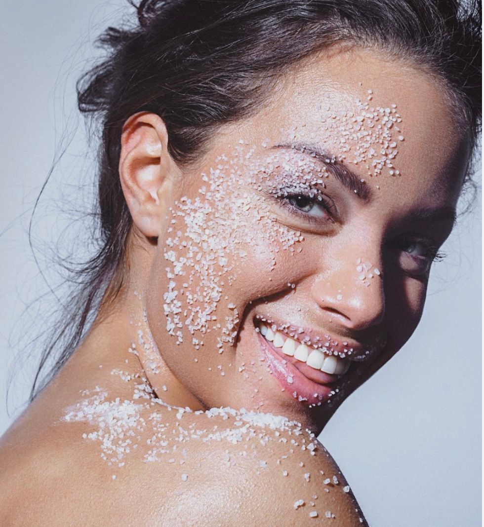 A woman is getting a facial treatment at a beauty salon.