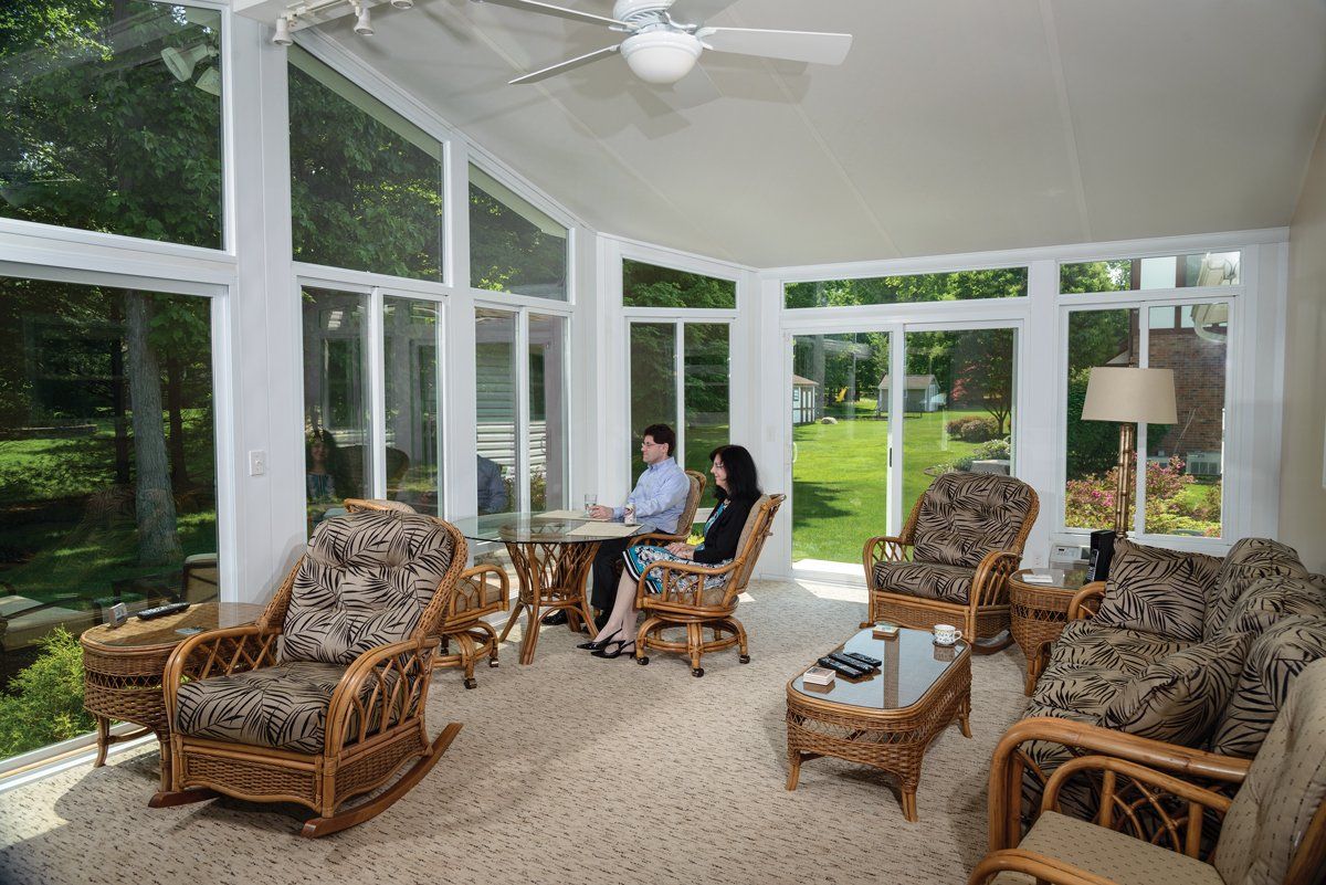 Man and Woman Sitting on Chair — Langhorne & Bensalem, PA — Besco Windows and Doors Inc.