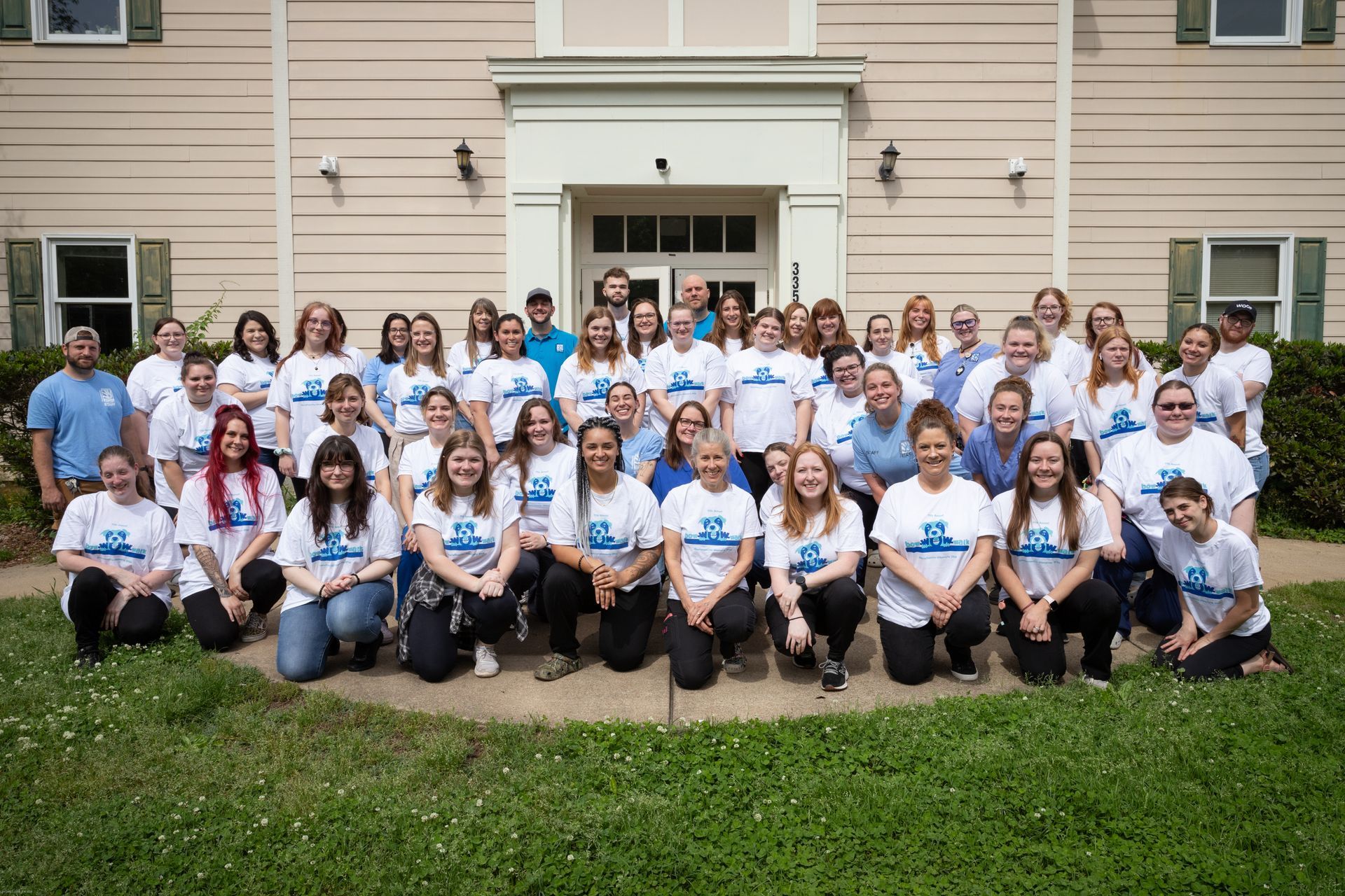 group staff photo outside of building