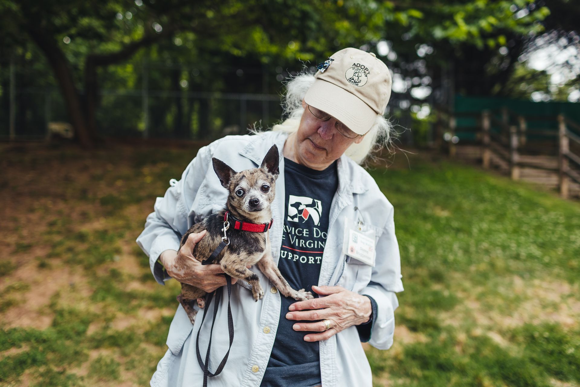 volunteer holding small dog