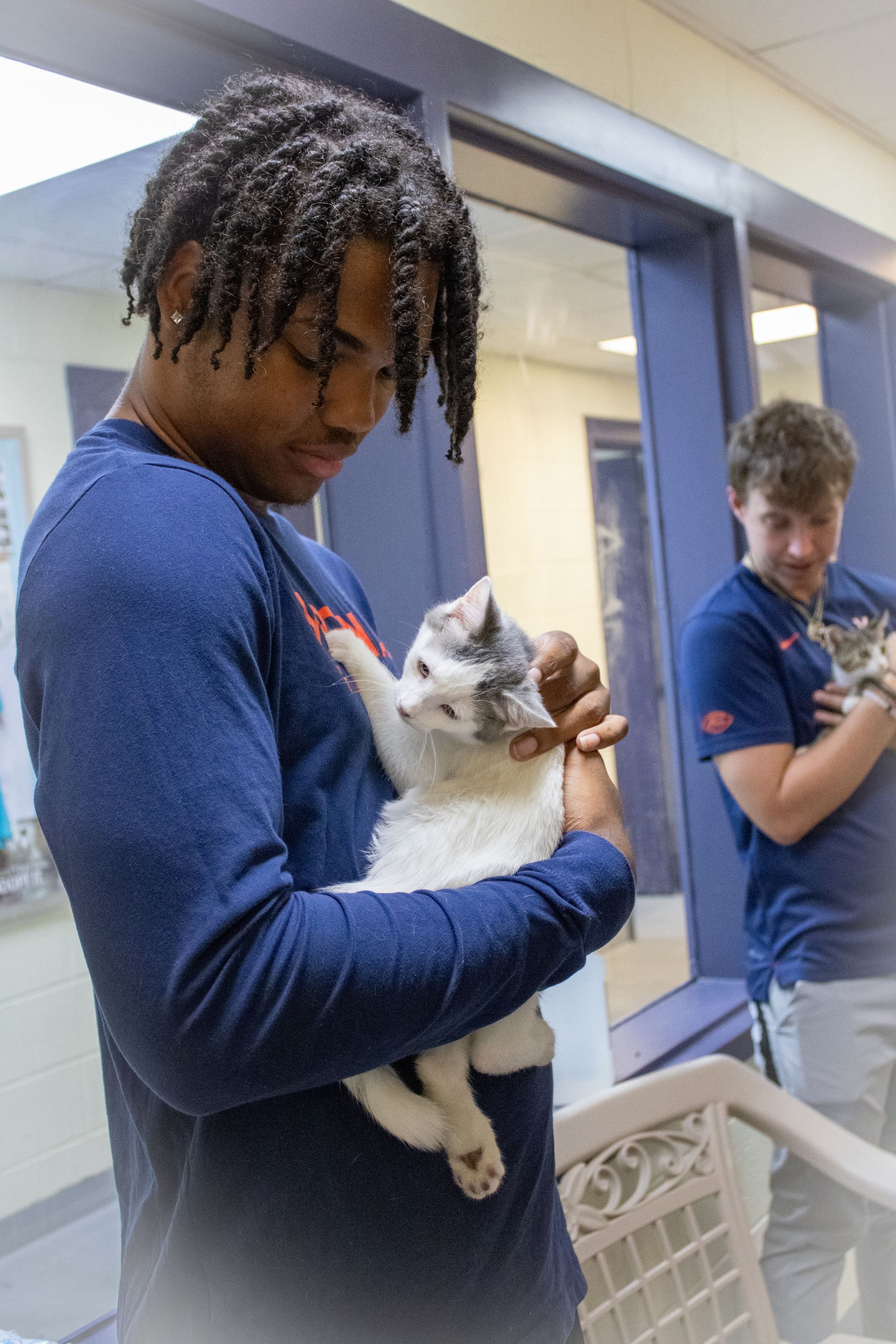 UVA Athlete holding white cat