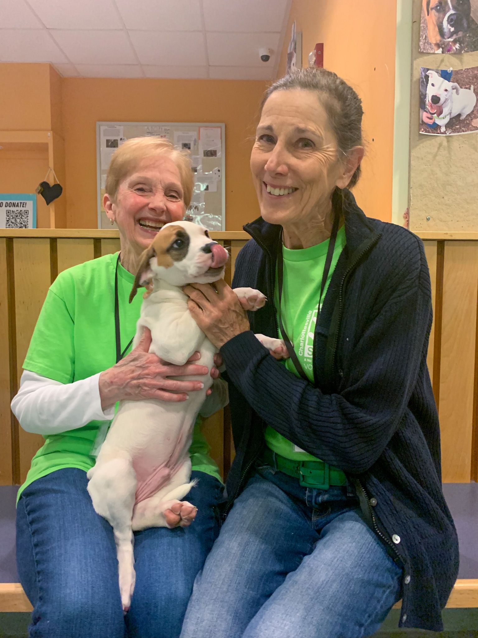 picture of two volunteers and dog
