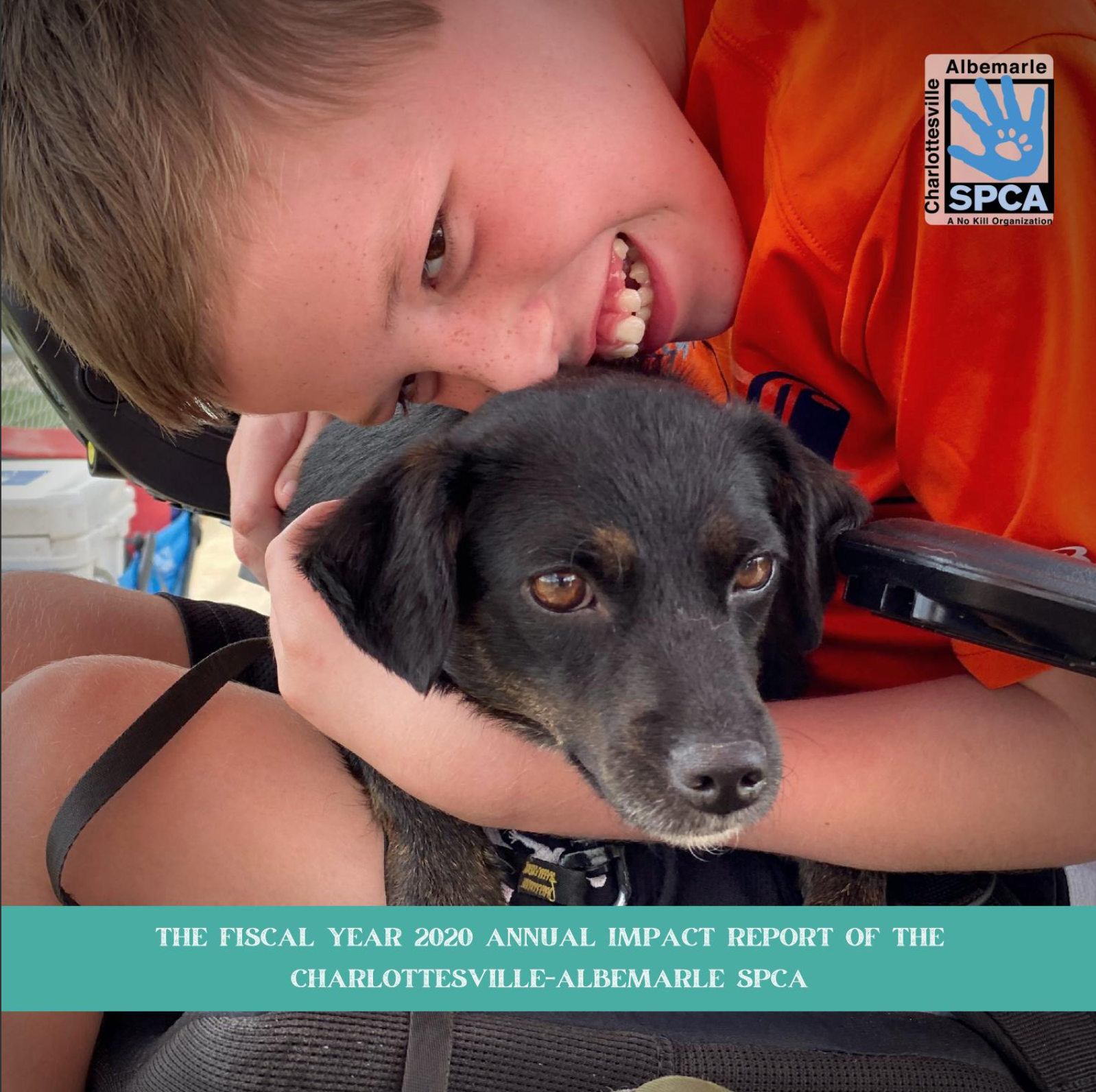 Photo of the 2020 Annual Report Cover, featuring a young boy holding a small black dog