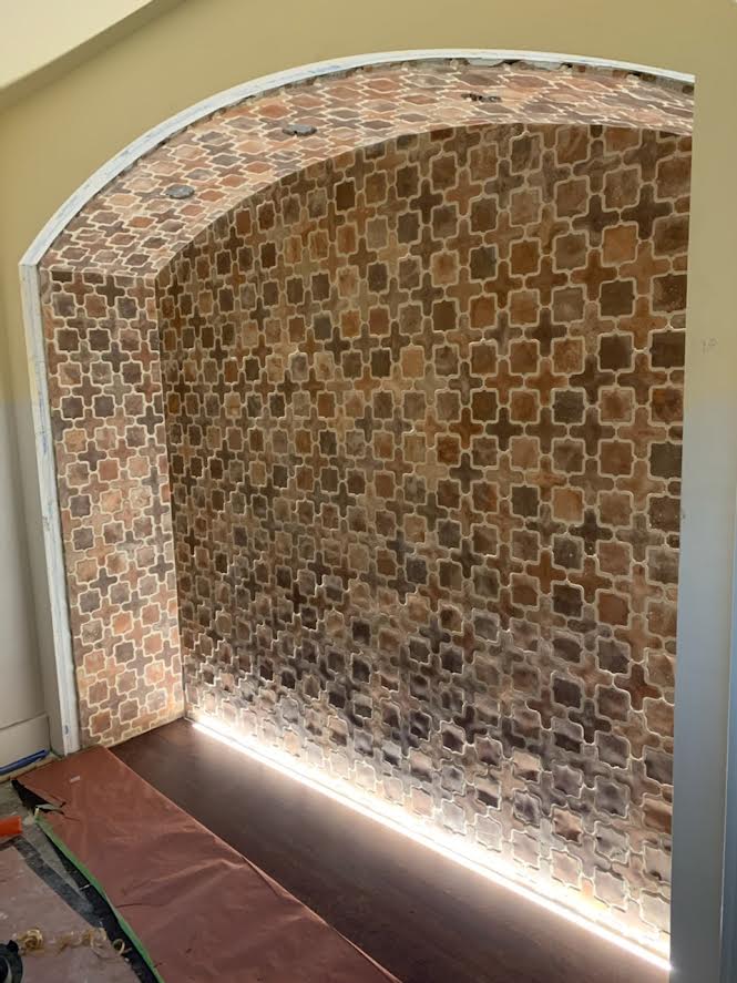 A brick wall with a light coming out of it