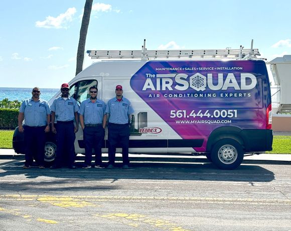 A group of men are standing in front of a van.