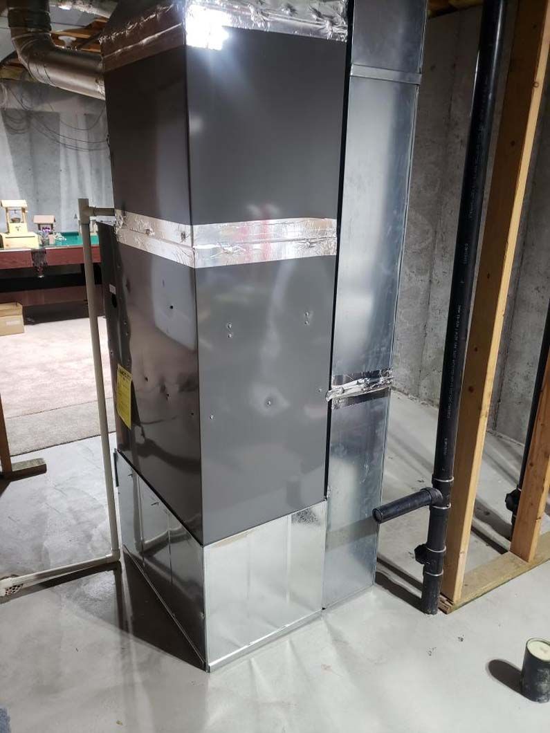 A large metal pipe is sitting in the middle of a room.