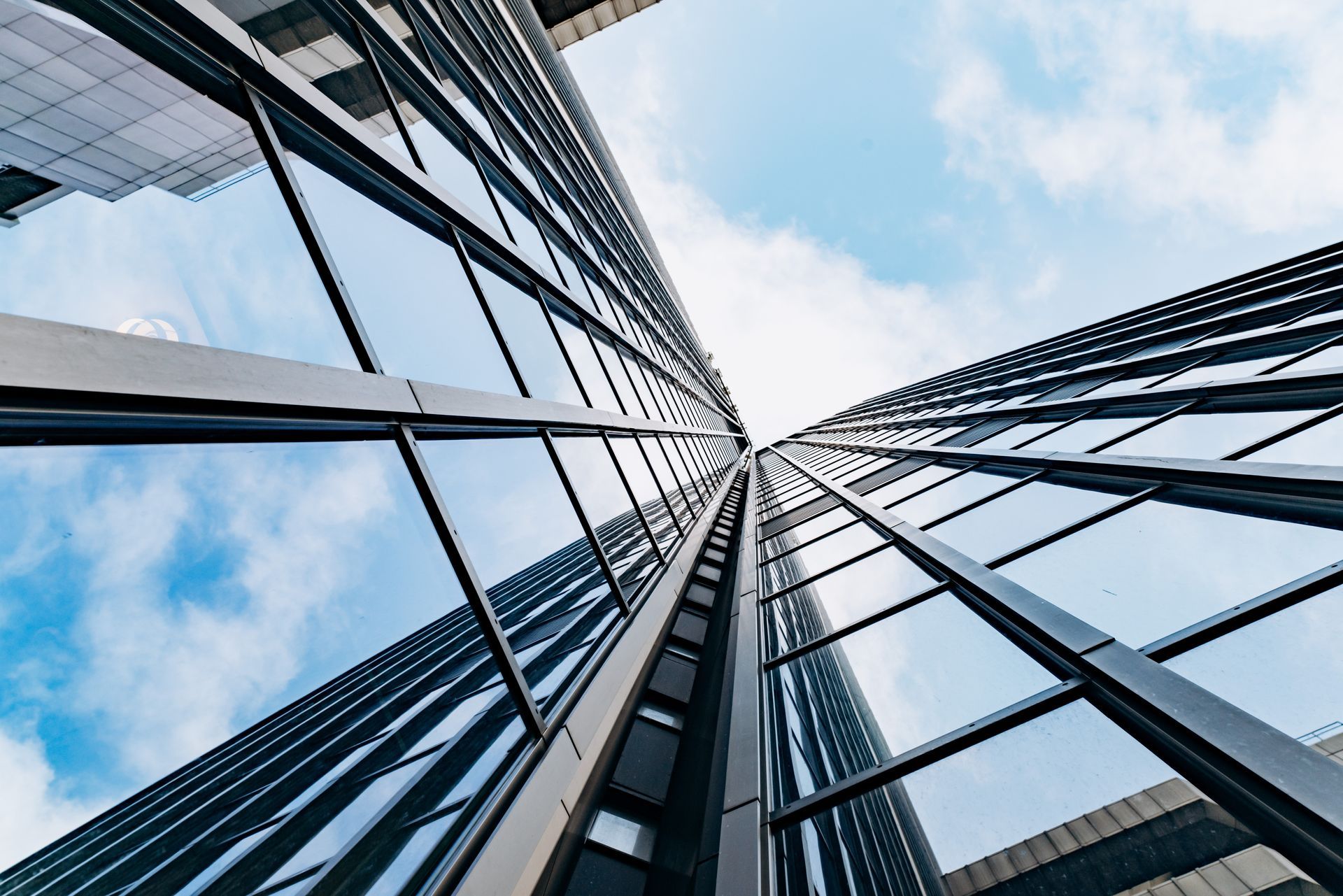 Looking up at a tall building with a blue sky in the background.