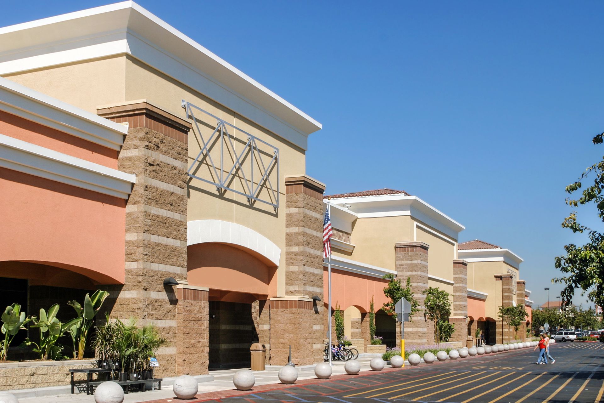 A large red target store with a lot of windows and a parking lot in front of it.
