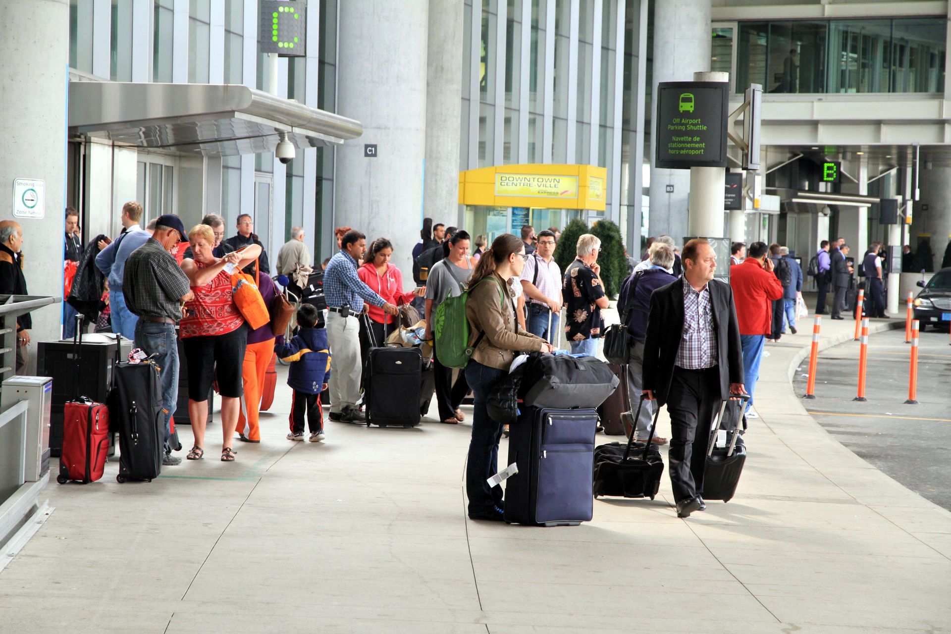 A large group of people are waiting in line at an airport