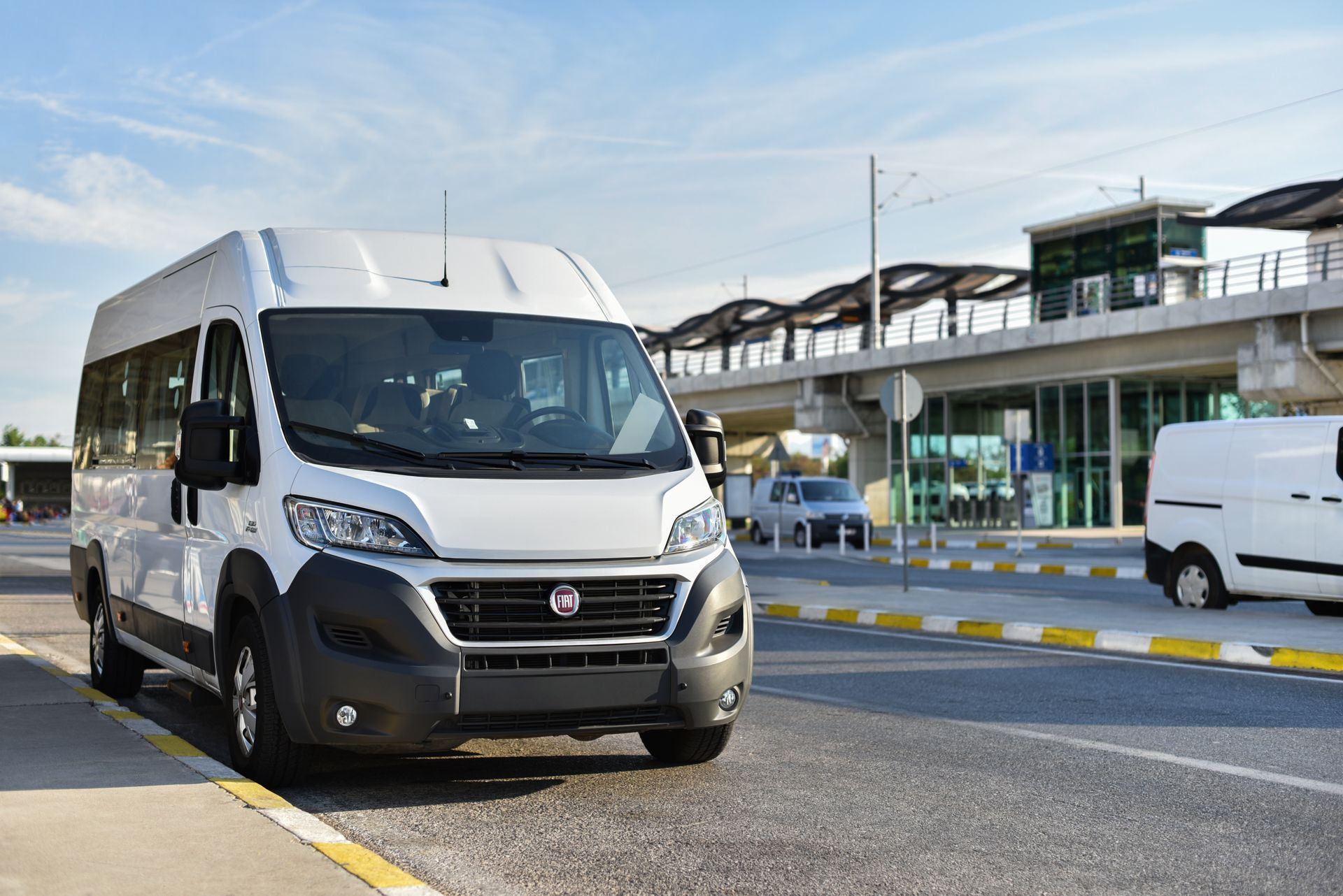 A white van is parked on the side of the road.