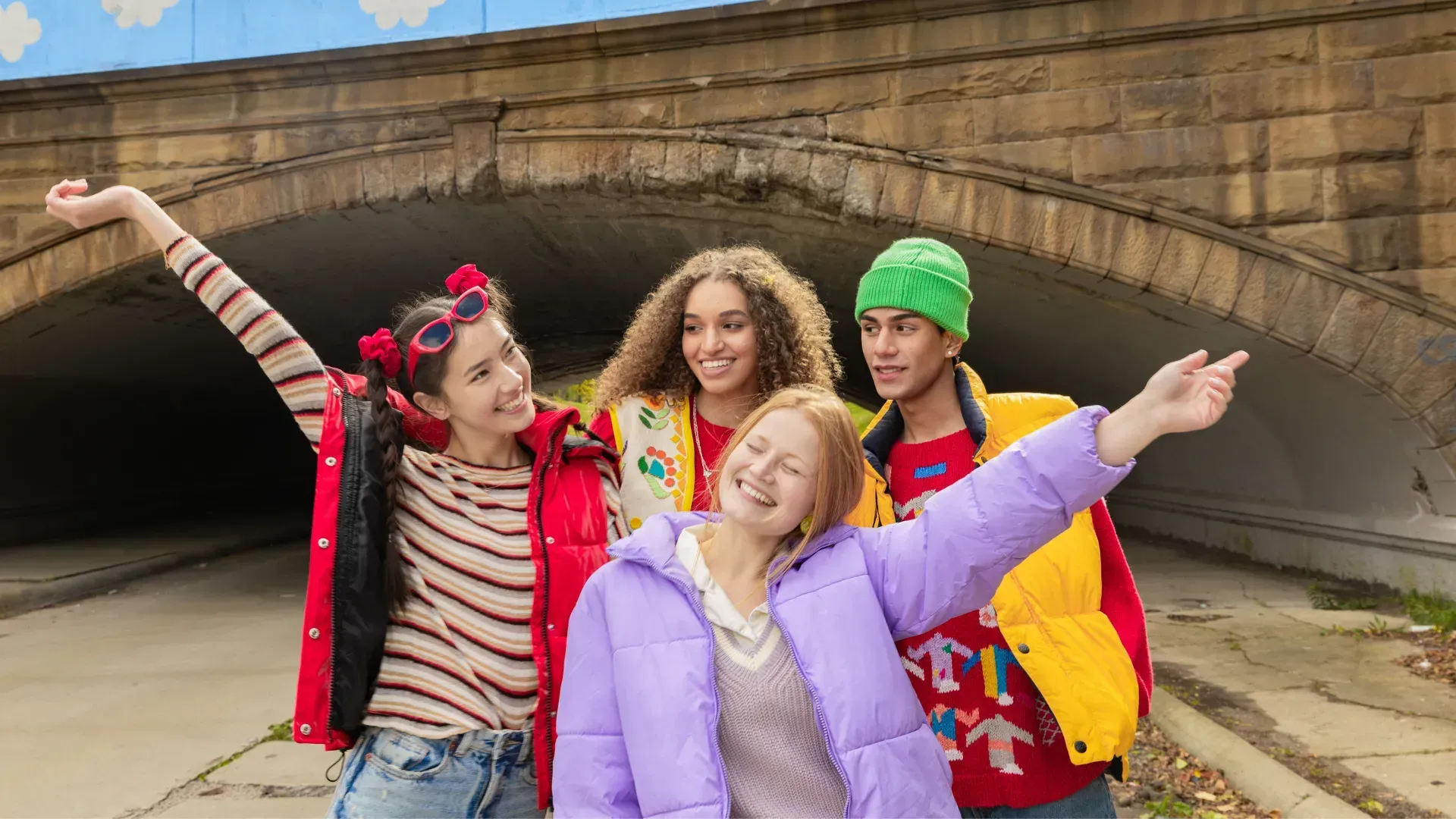A group of young people are posing for a picture in a tunnel.