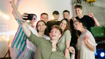 A group of young people are taking a selfie together.