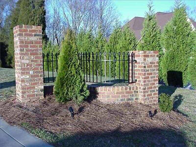 Custom Fencing — Brick Wall with an Iron Fence in Winston-Salem, NC