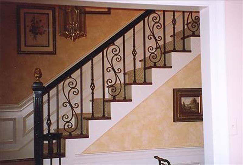 Stair Iron Handrailings — Staircase with Hanging Pictures in Winston-Salem, NC