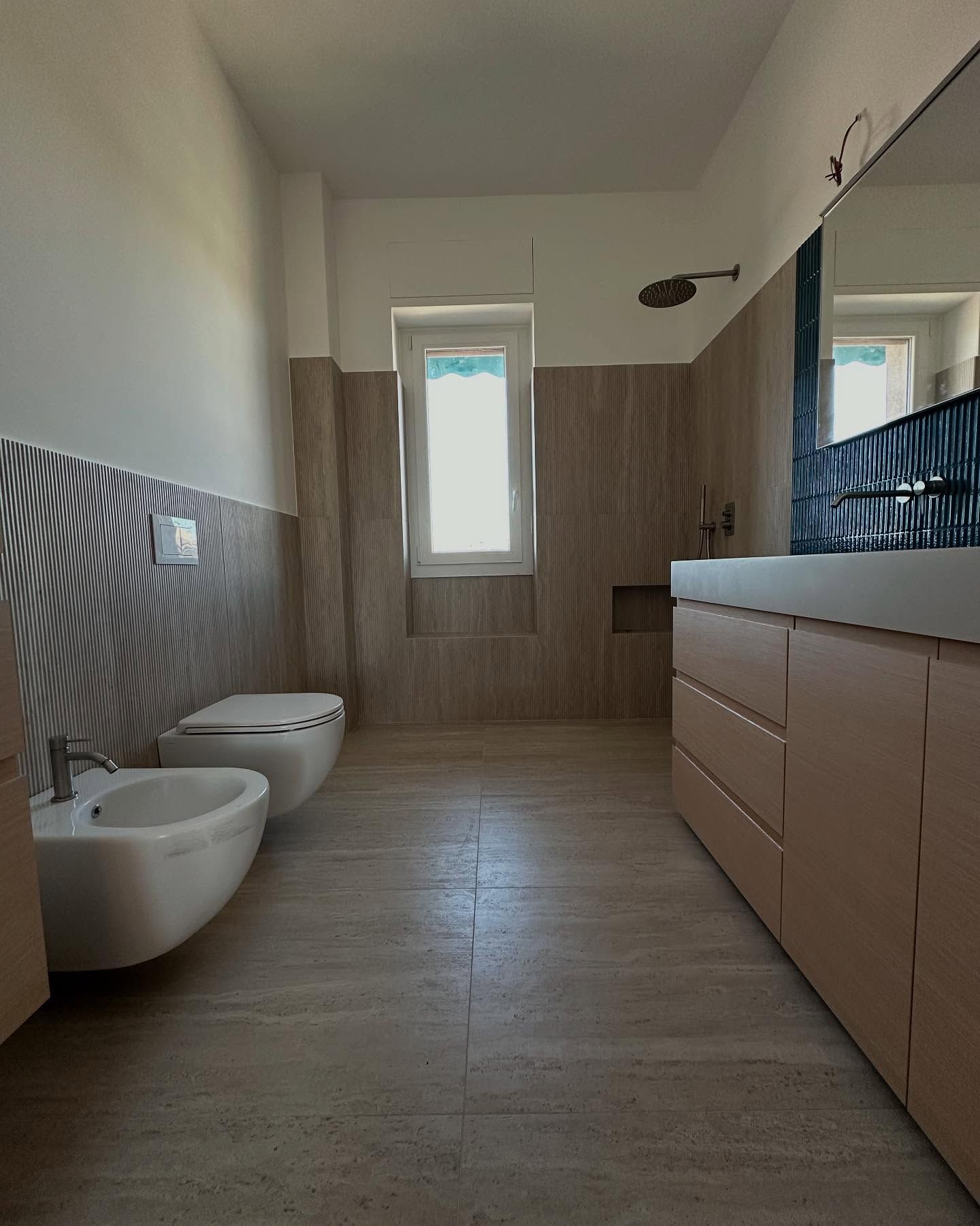 Un bagno con due WC e un lavandino