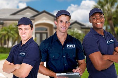 Three men are posing for a picture in front of a house.