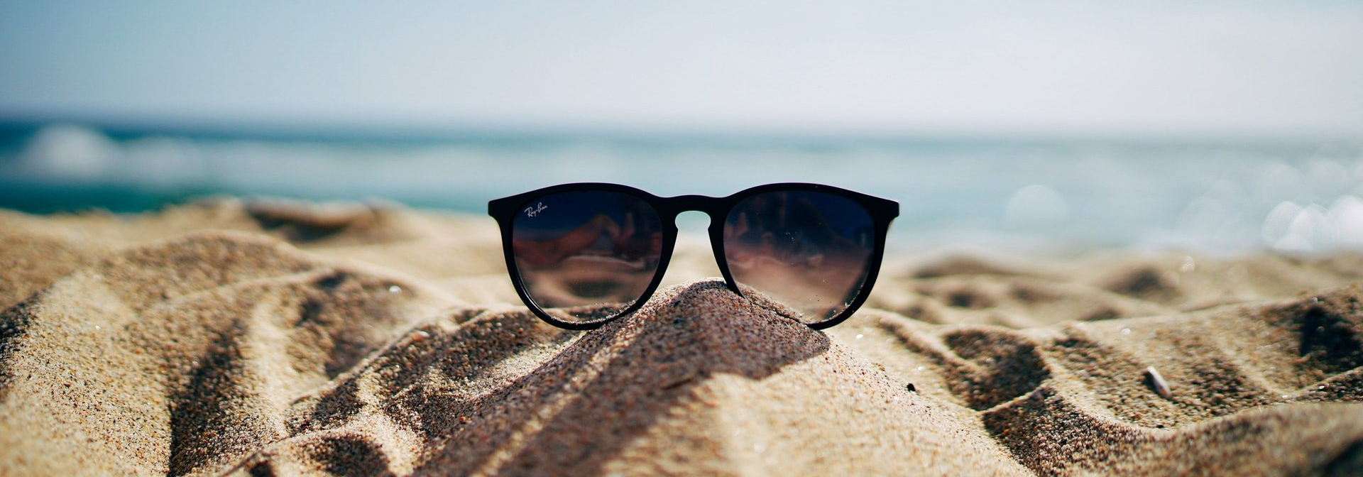 Sunglasses in Sand at Beach