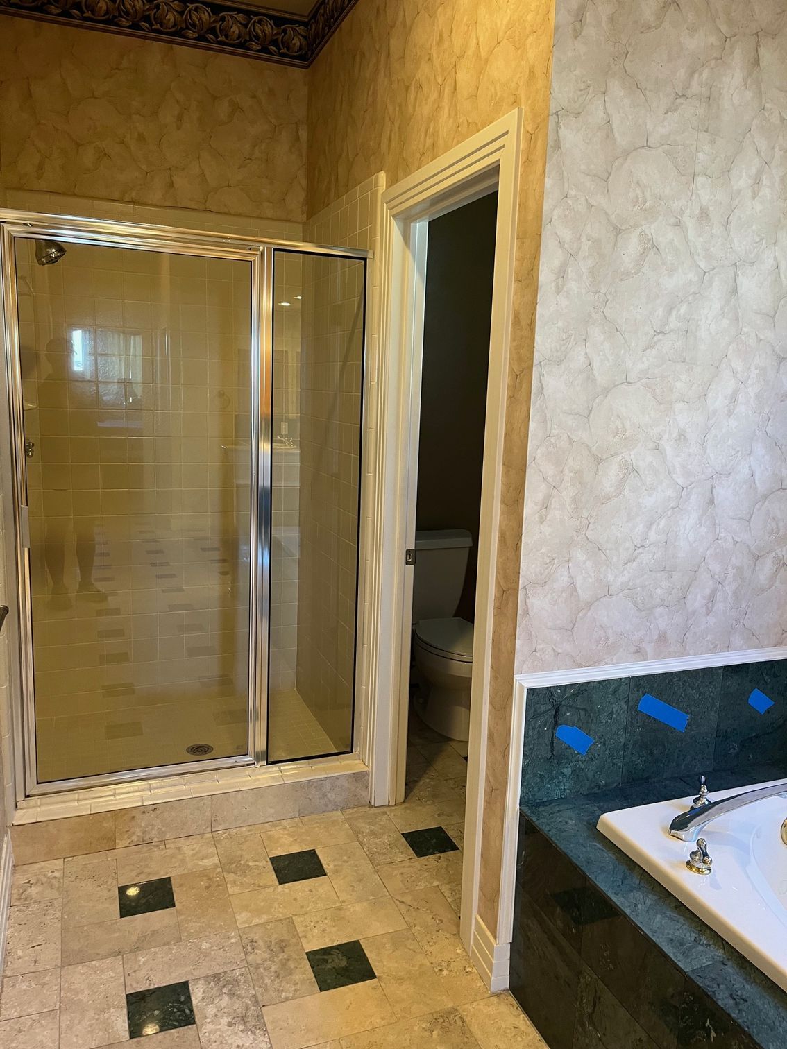 A bathroom with a walk in shower and a bathtub